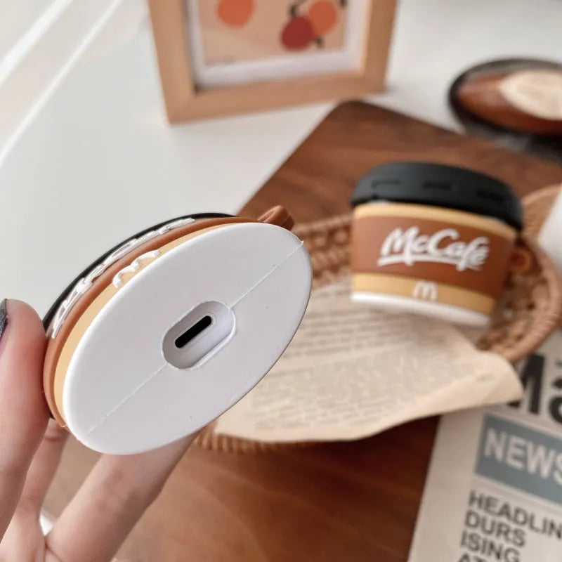 Brown silicone coffee cup-shaped earphone case for Apple AirPods with irregular printed design, front view, compatible with AirPods 1/2 and Pro 3