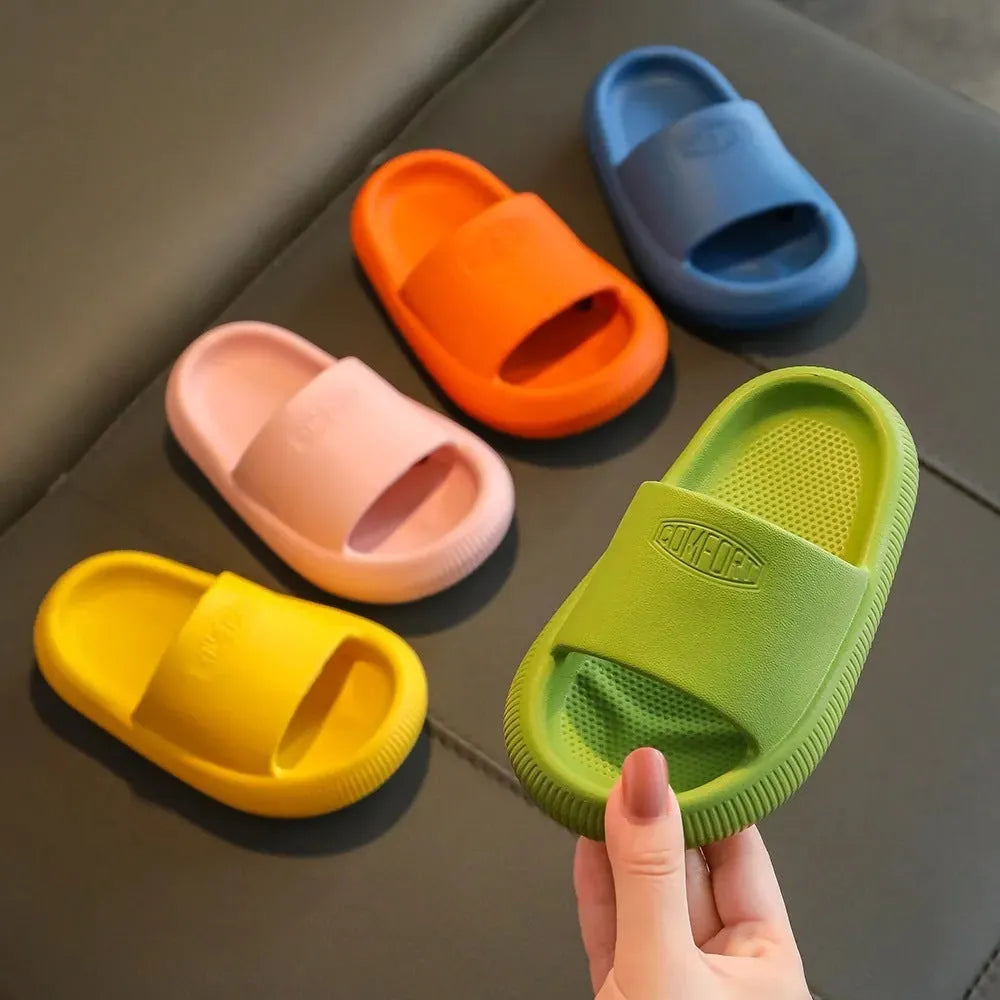 Children's mixed colour EVA slippers with textured sole, shown in blue, green, orange, pink, and yellow.
