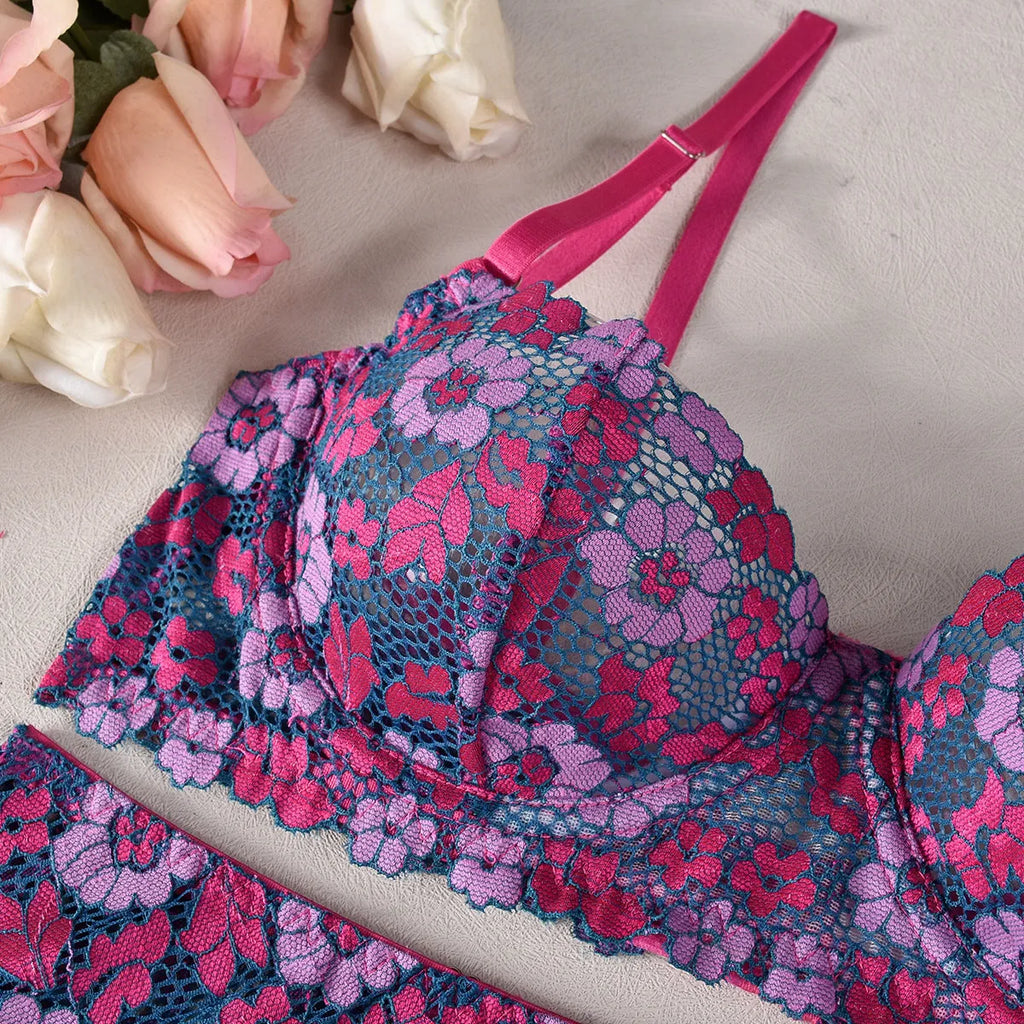 Rose red women's two-piece bikini with embroidered contrast detail on a mannequin.
