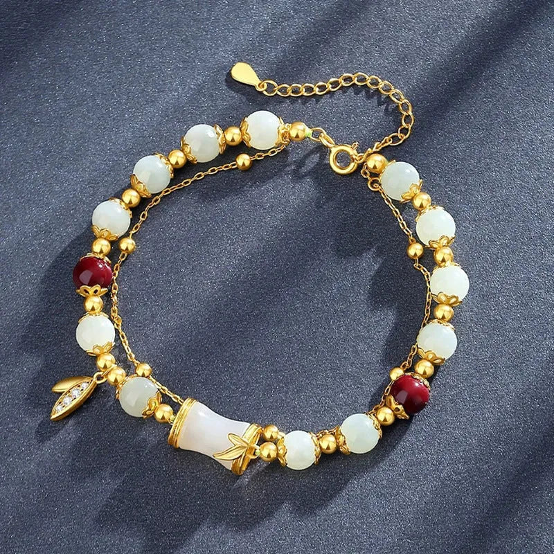 Bamboo-themed bracelet with a coloured glass flower and ruyi pattern in beige, green, light green, or white.
