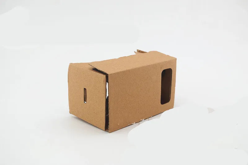 Pink and white cardboard VR glasses with adjustable rubber head strap and 3D lenses for smartphones.