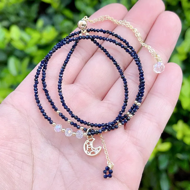 Blue gold sand stone three-ring multi-layer bracelet for women on a white background.