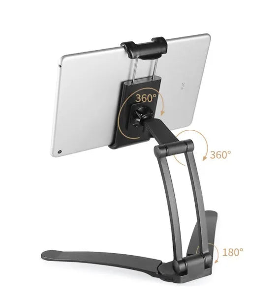 Silver aluminium desktop tablet stand holding a tablet, showing 360-degree rotation and dual adjustable clip design.