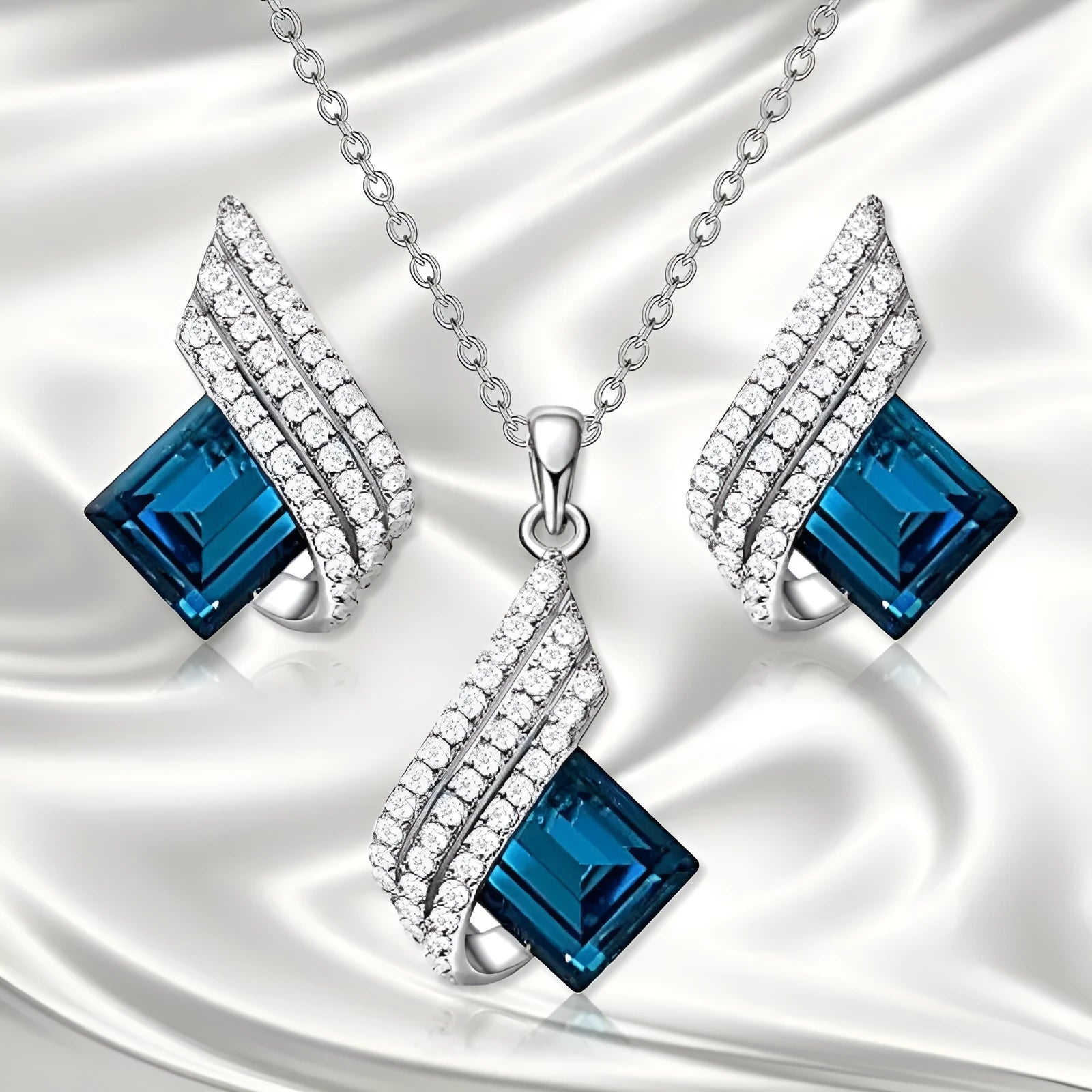 Women's electroplated alloy and glass jewellery set showing necklace with cross chain design and matching ear studs