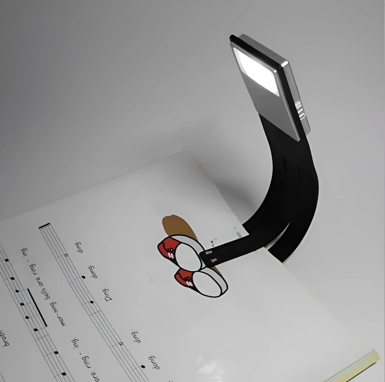 Black folding LED reading lamp showing extended 205mm length and adjustable brightness settings