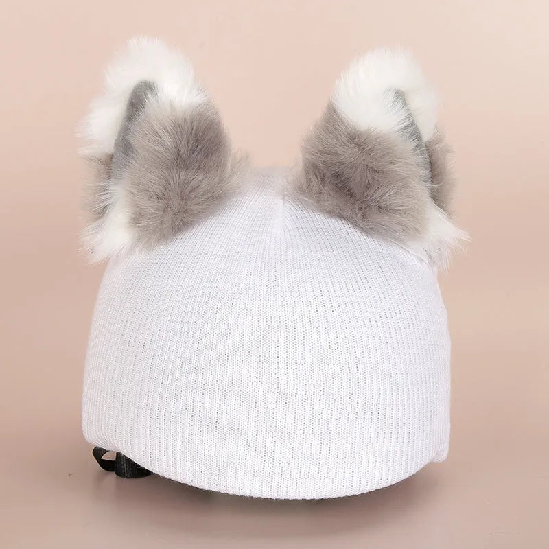 Soft plush cartoon character cover stretched over a pair of black on-ear headphones.