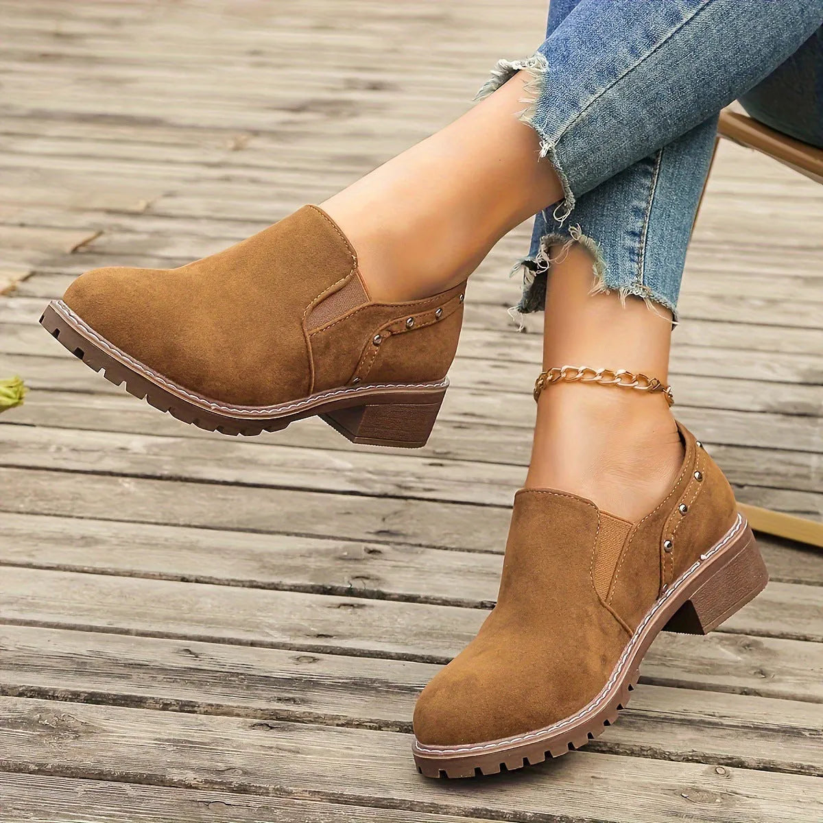 Women's light brown suede ankle boots with a low block heel and elasticated ankle cuff.