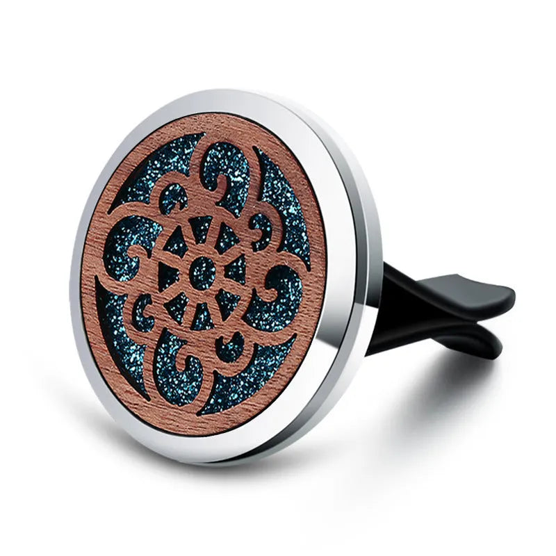 Round car vent aromatherapy clip in alloy wood construction showing hollow centre for incense