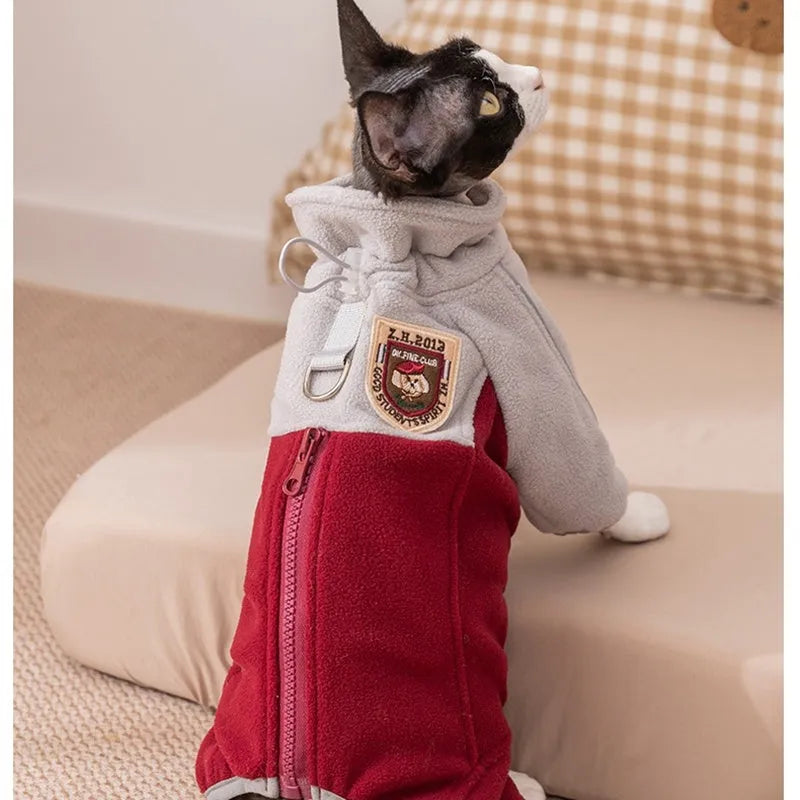 Four-legged fleece pet jacket in colour block design with full zipper and badge patch, sizes S-XXL for cats and small dogs.
