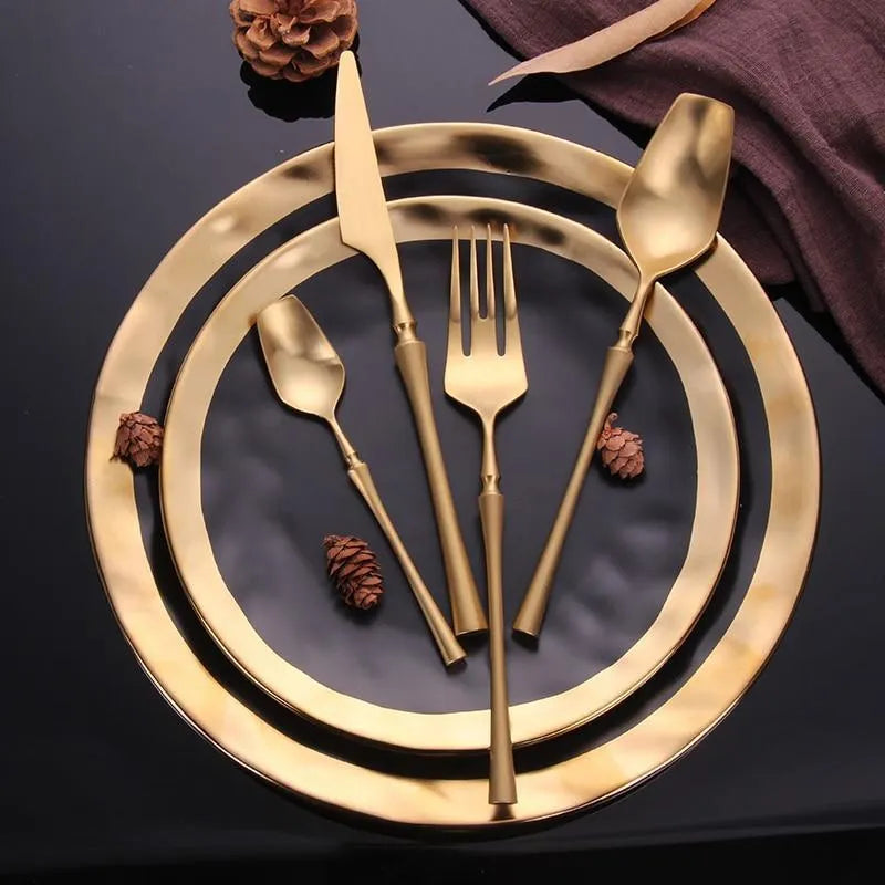 Stainless steel cutlery set with main knife, main fork, main spoon, and teaspoon in silver finish