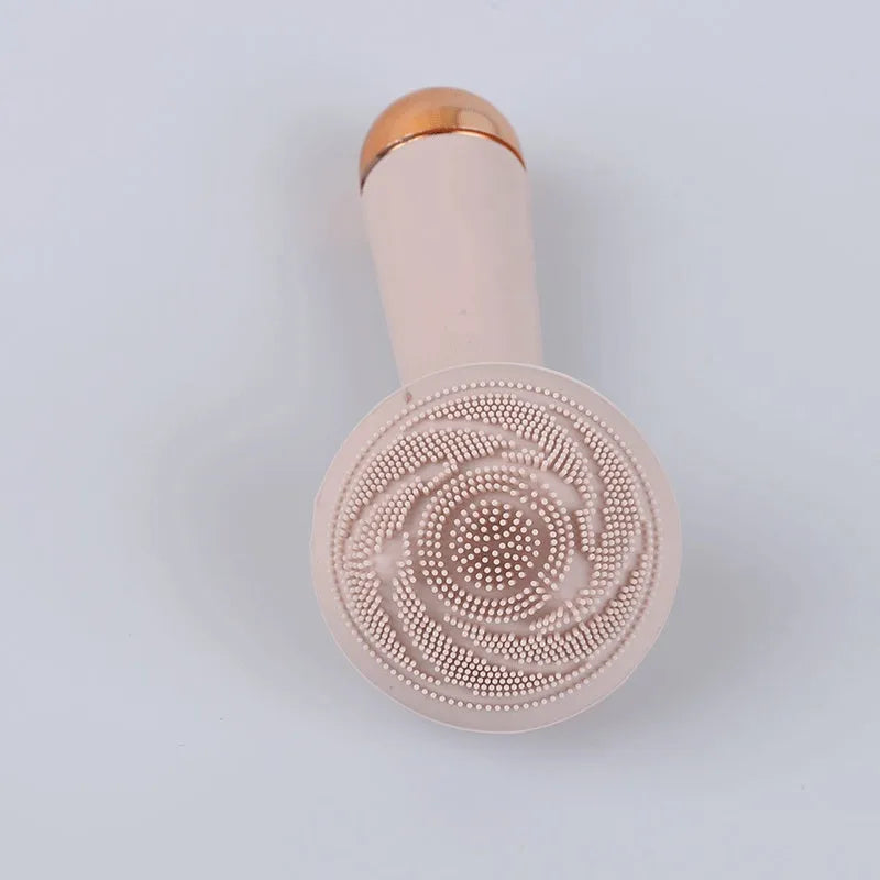 Electric face wash cleaner with pink silicone brush head on a light background