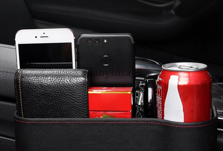 PU leather car seat gap storage box in black holding a smartphone and wallet between the console and seat
