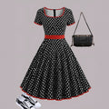 Multicolour polka dot midi dress with a structured square neckline and a front metal zipper closure.