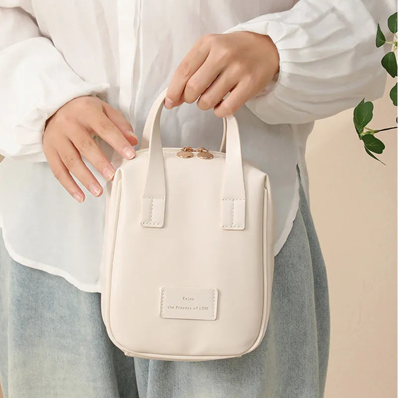 Handle-top cosmetic bag shell-shaped design in cream white with high capacity storage for travel and home use