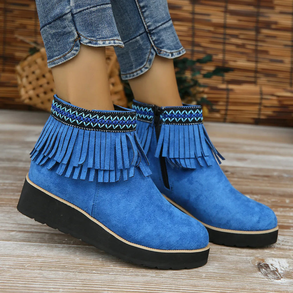 Women's dark brown suede wedge ankle boots with a tassel and side zipper on a thick rubber sole.