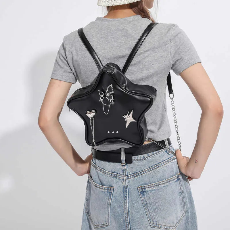 Soft black PU women's mini messenger bag worn as a backpack on a model.
