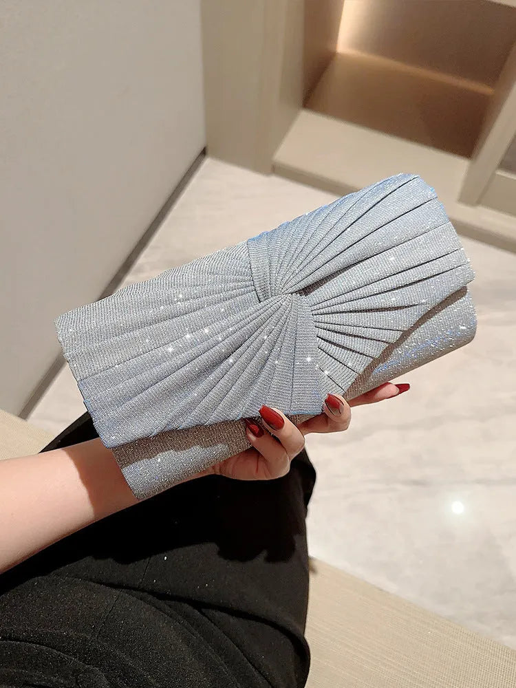 Horizontal square dinner clutch in silver or gold with woven exterior, open pocket, and internal phone bag.