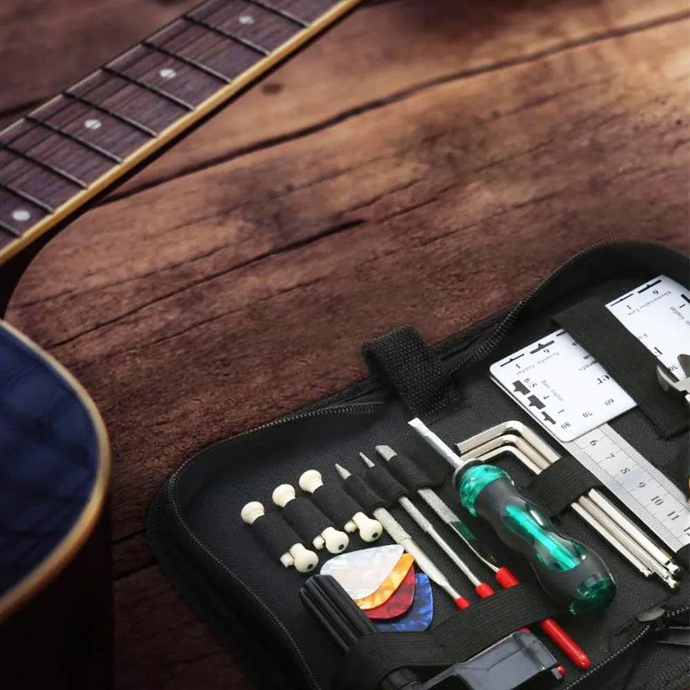 Black plastic guitar repair kit case open to show 16 chrome-plated steel tools including cutters, winders, and screwdrivers.