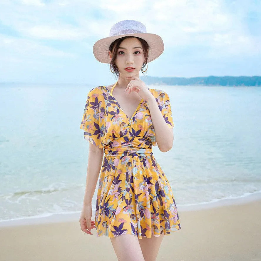 Yellow floral pattern women's one-piece polyester swimsuit on mannequin