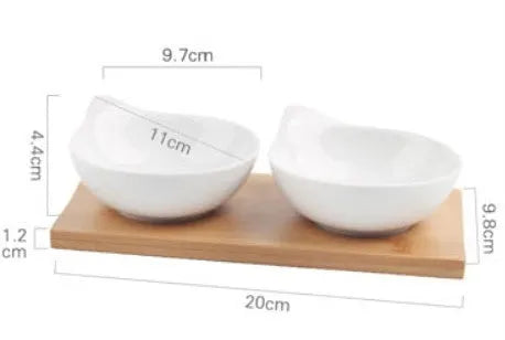 Ceramic multi-compartment dried fruit dish plate on a wooden board, showing separate sections for snacks.