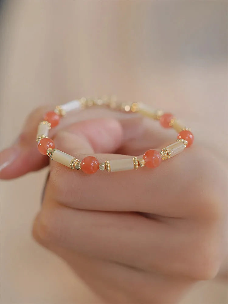 Women's bamboo joint bracelet with polished 6mm Hetian jade or South red agate beads.