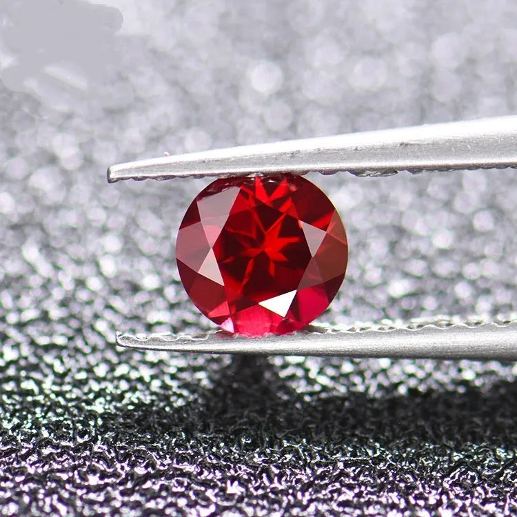 Artificial ruby gemstone in multiple cuts including round, princess square, and water drop shapes