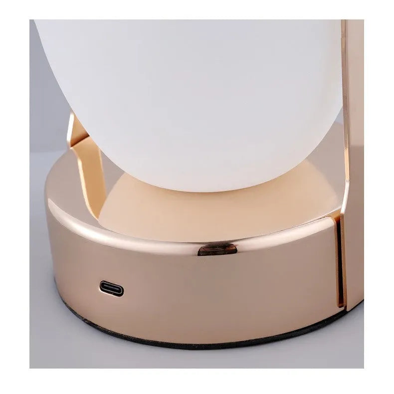 Rechargeable bedside table lamp with metal holder, golden, portable for camping and emergency use, USB charging