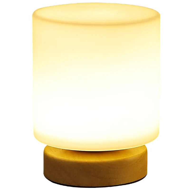 Nordic style solid wood USB table lamp in a cube shape with touch dimming on a wooden desk.
