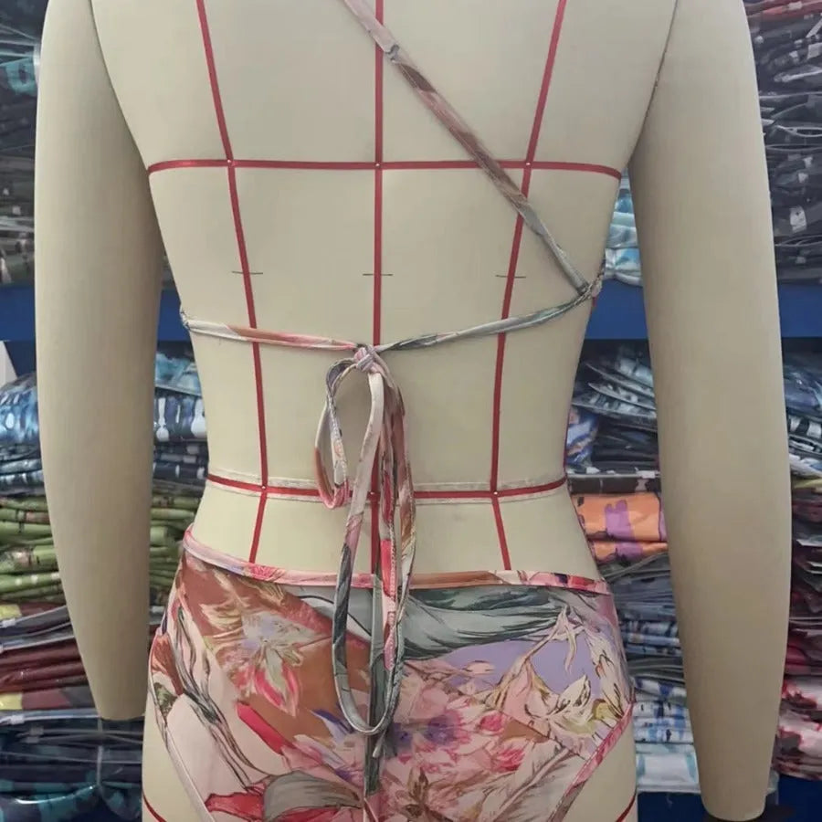 Women's rose gold patterned one-piece swimsuit on hanger
