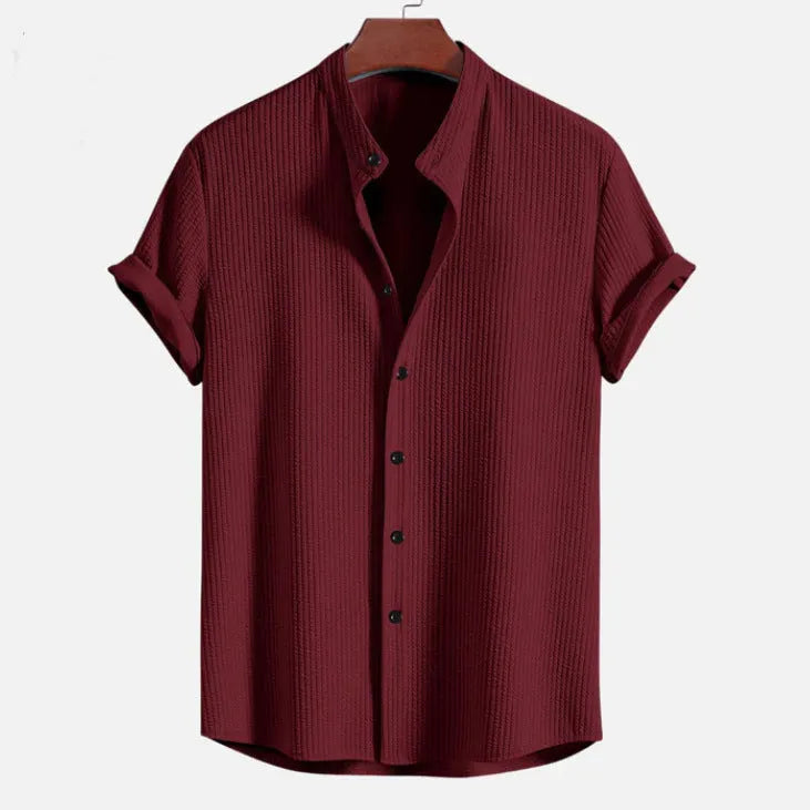 Mans loose-fitting short sleeve casual shirt in solid colour on hanger.