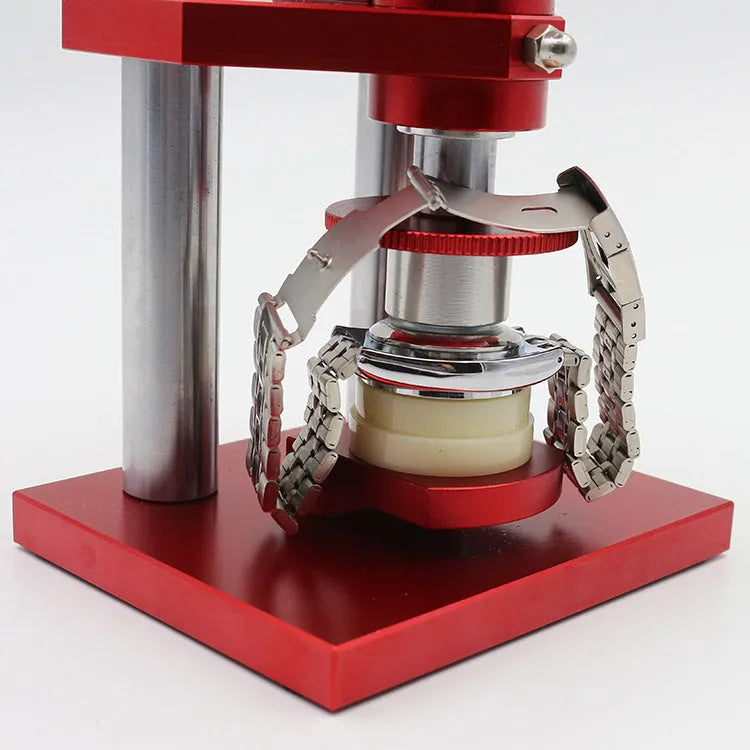 Watch back cover press tool, a spiral cap presser machine, shown with a set of 20 plastic moulds for different watch sizes.