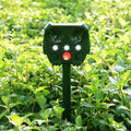 Green solar-powered ultrasonic animal repeller unit with LED light for outdoor pest control.