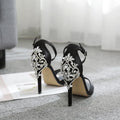 Black suede women's high heel shoes with fish mouth toe and rhinestone decoration on a rubber sole.