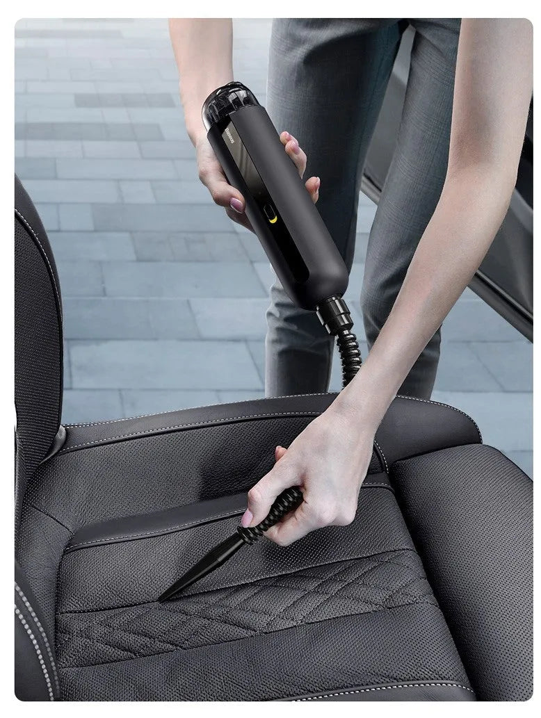 Starry sky black handheld car vacuum cleaner with a blowing hose attachment on a car seat.