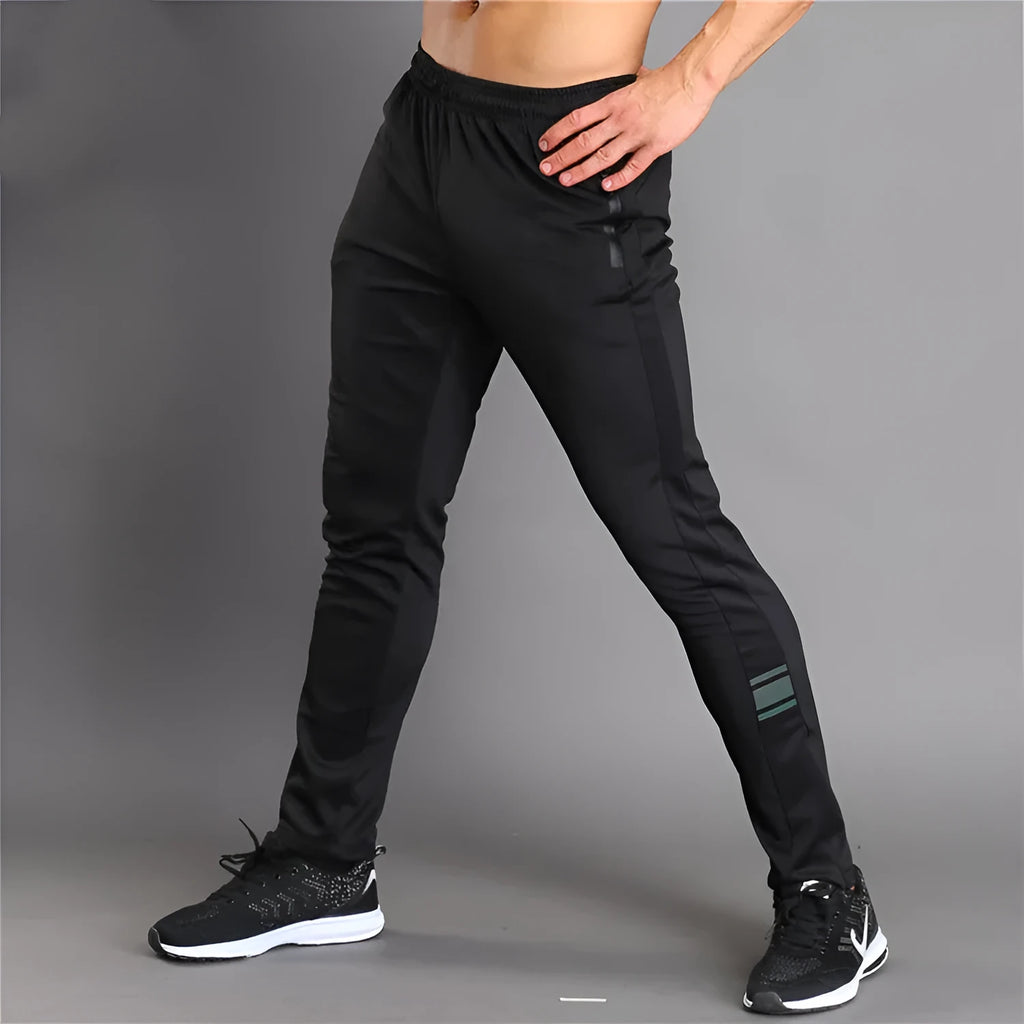 Black slim-fit running fitness trousers with reflective printing and zipper pockets on a model