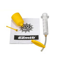 EZmtb bicycle hydraulic disc brake bleed kit with syringes, bottles, adapters, and tools laid out.