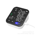 White electronic blood pressure monitor with large LCD screen and attached upper arm cuff