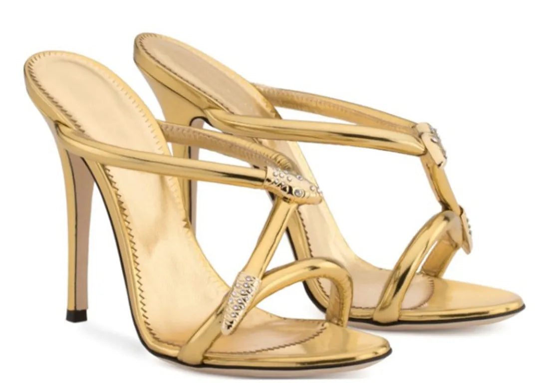 Black satin stiletto sandals with 9cm heel and decorative buckle shown on a white background
