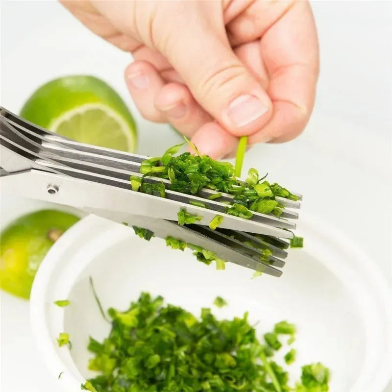 Stainless steel multi-layer kitchen scissors for cutting green onions and herbs on a chopping board.