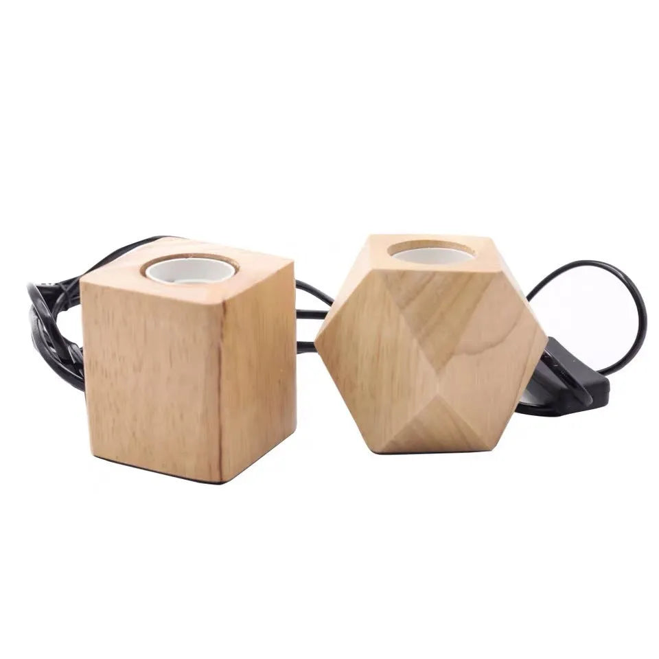 Retro-style square wooden lamp holder on a table next to a power cord.