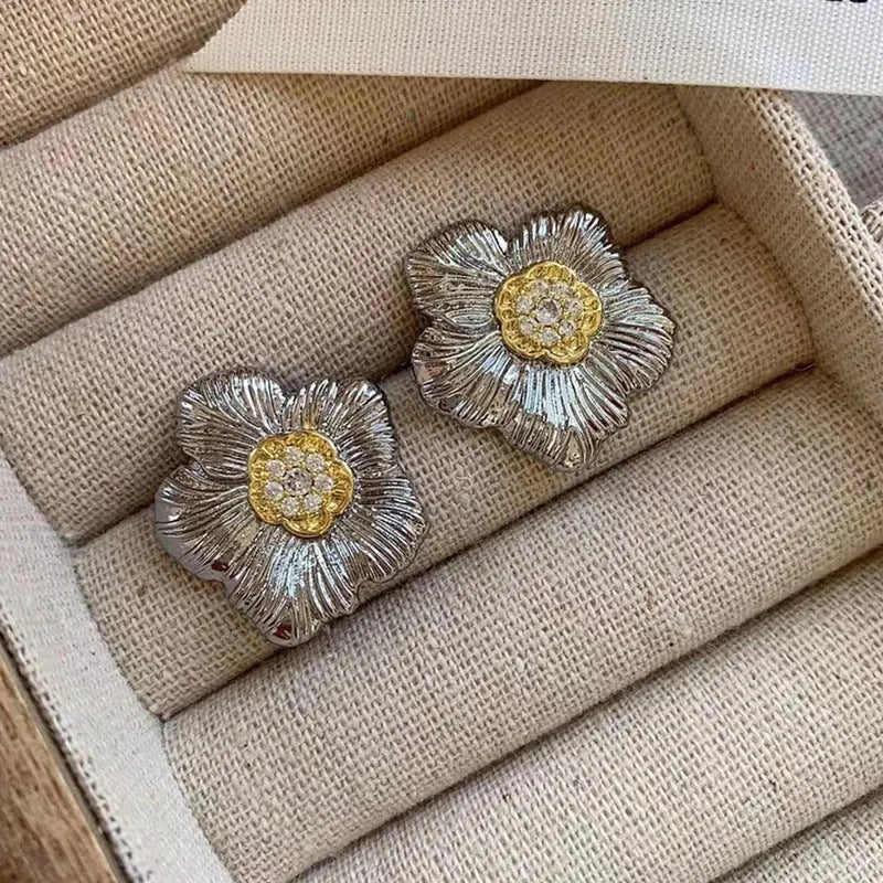 Retro copper stud earrings with a textured gardenia design in a two-tone electroplated finish.