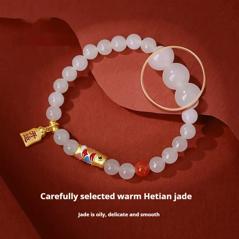 S925 sterling silver bracelet with a natural Hetian jade koi fish charm and cold enamel details.