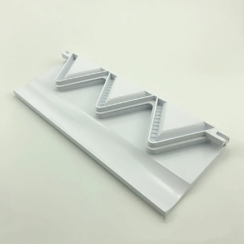 White plastic dumpling mold 28.5cm long on plain background