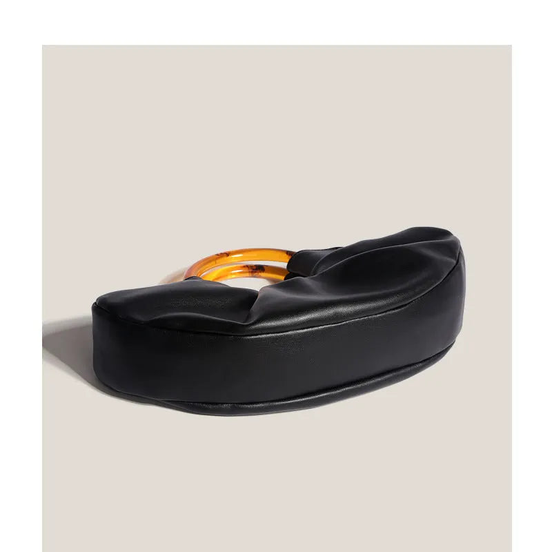 Niche Horn Bag acrylic ring handbag in black PU leather with fold design detail