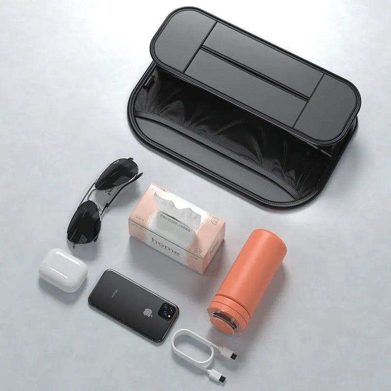 Black leather car seat storage bag with customisable compartments mounted on vehicle seatback