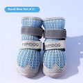 Pair of light blue breathable dog shoes with mesh upper and PU sole on a wooden surface.