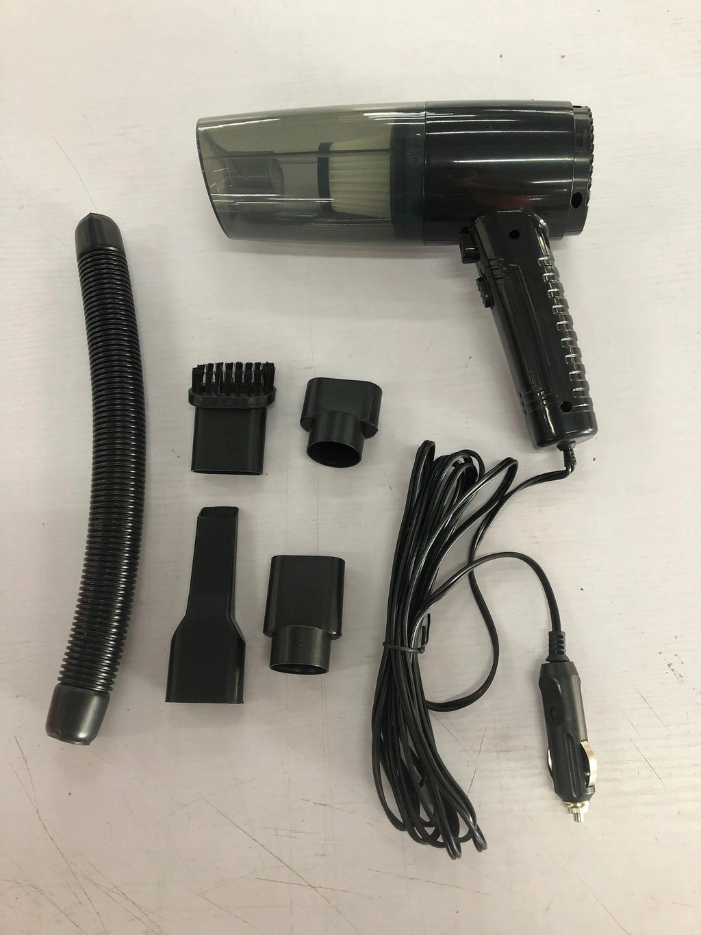 Black and white dual-purpose car vacuum cleaner with long cable and five suction head attachments.