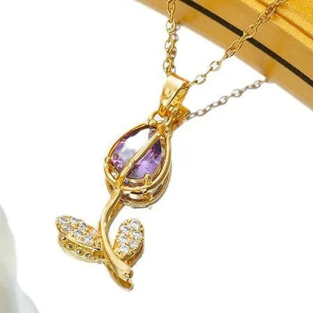 Gold tulip pendant necklace with zircon stones on an adjustable O-ring chain, showing colour options.