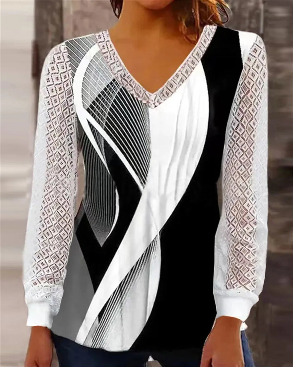 Purple women's loose V-neck top with hollow-out lace detailing on a hanger.