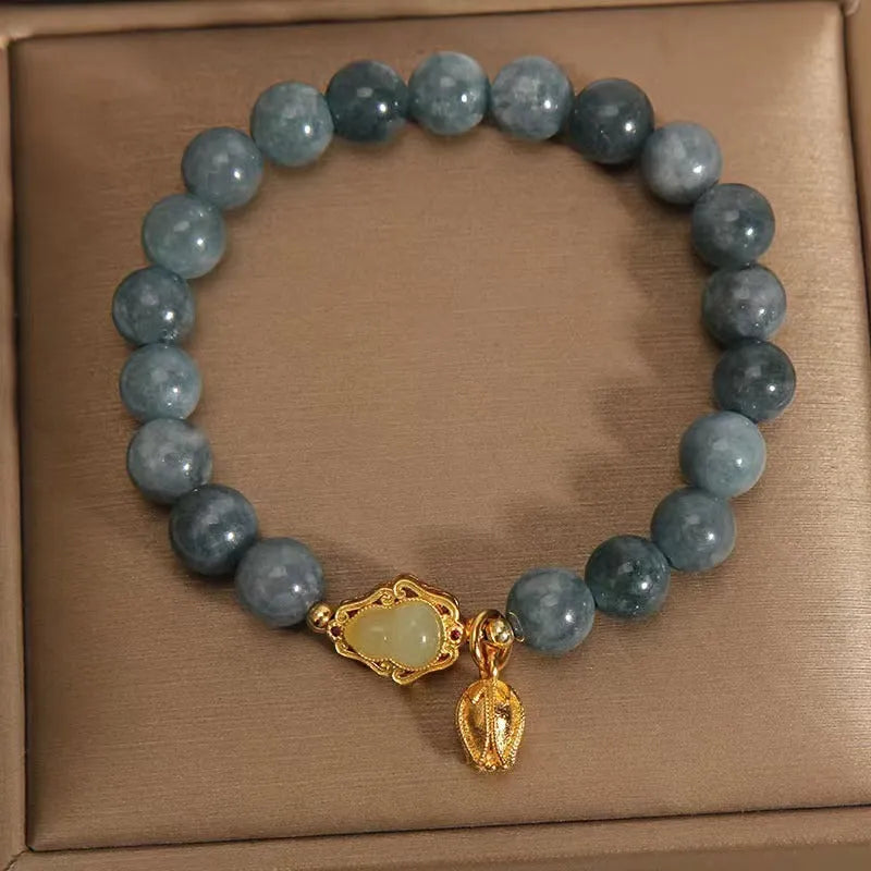 Natural stone bracelet for women with a blue electroplated gourd lotus flower pendant.